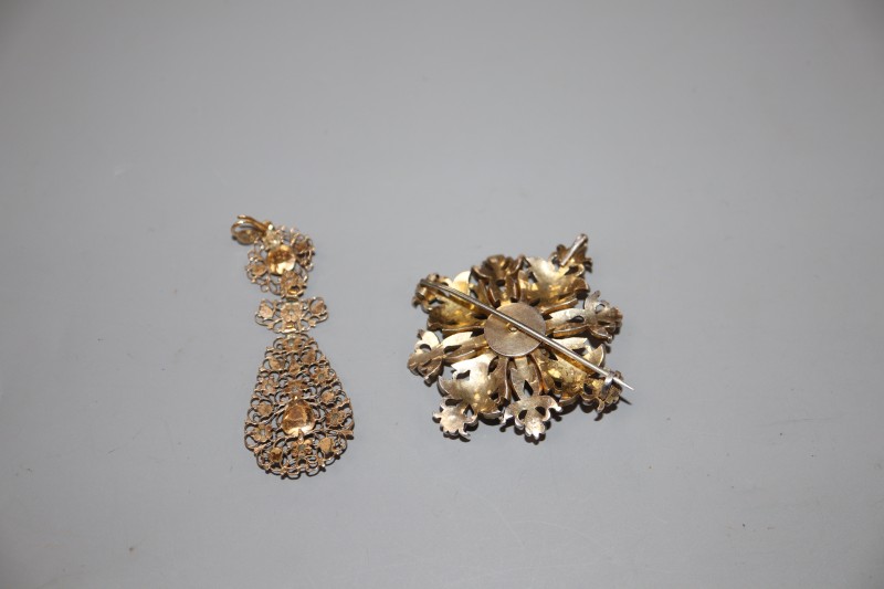 An Indian? white and yellow metal, rose cut diamond and ruby set flowerhead brooch, 48mm & an earring.